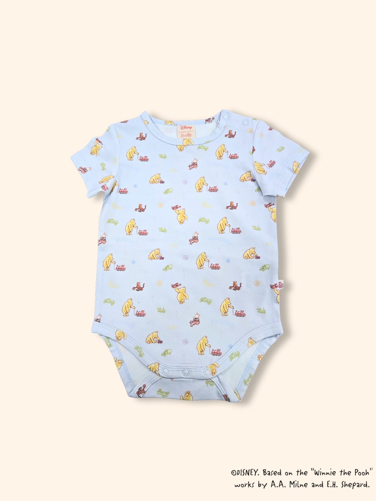 Blue Classic Pooh baby onesie with playful train print, short sleeve design