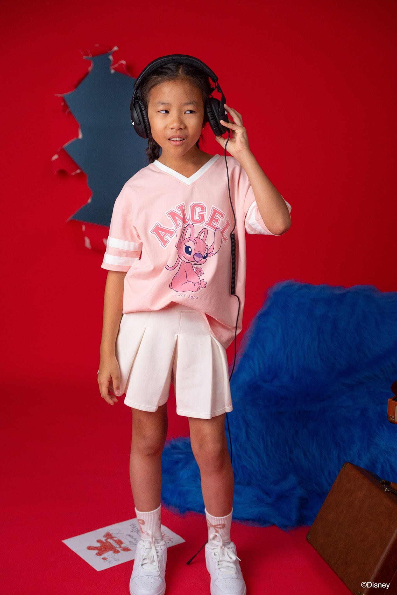 Girl wearing Stitch tee shirt and headphones