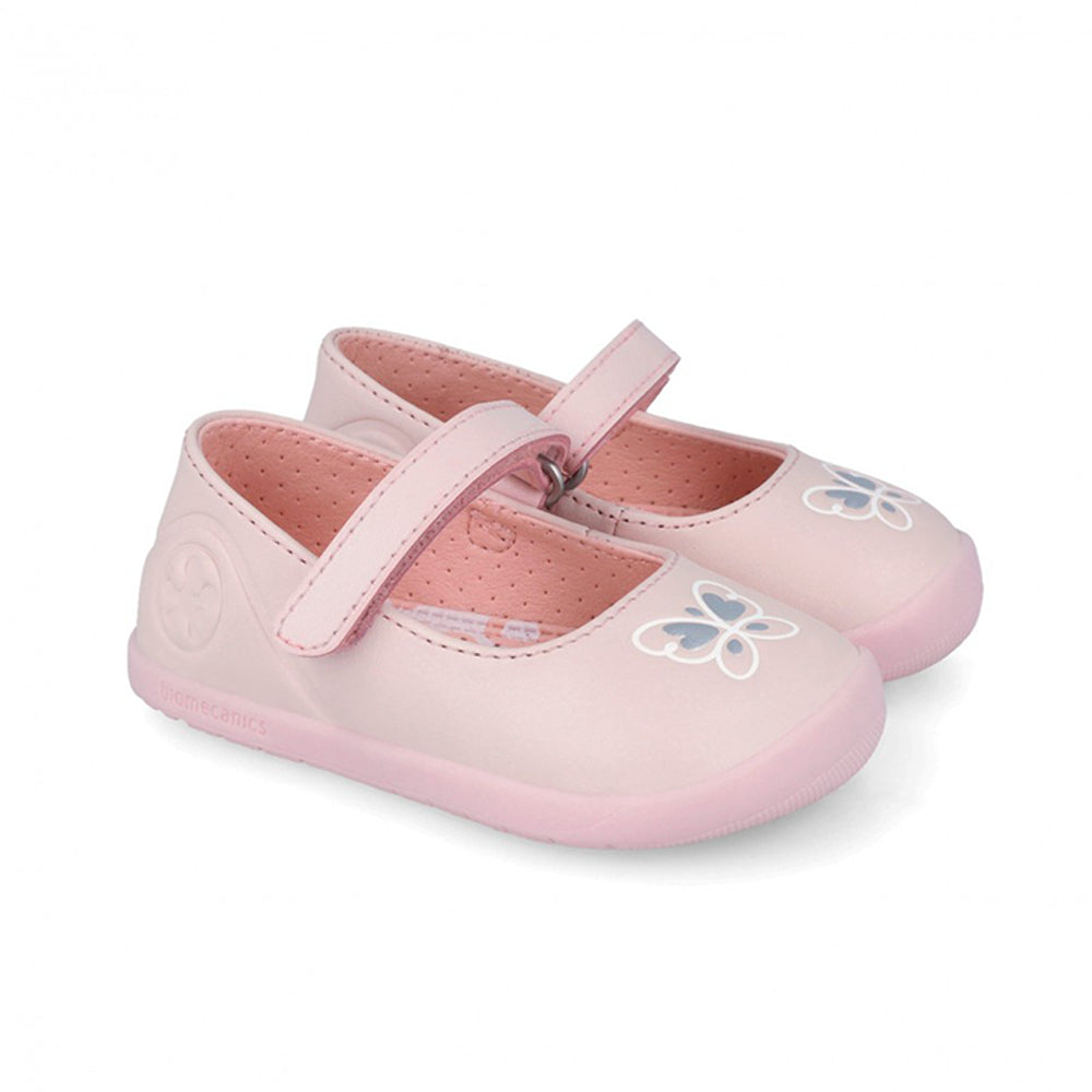 Pair of pink children's shoes with butterfly designs on a white background