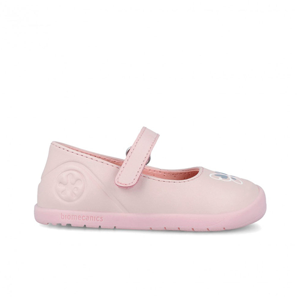 Pink children's shoe with a strap on a white background