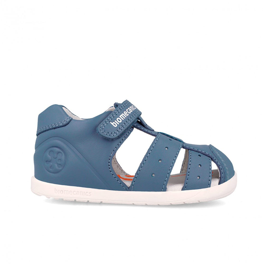 Blue children's sandal with white sole on a white background