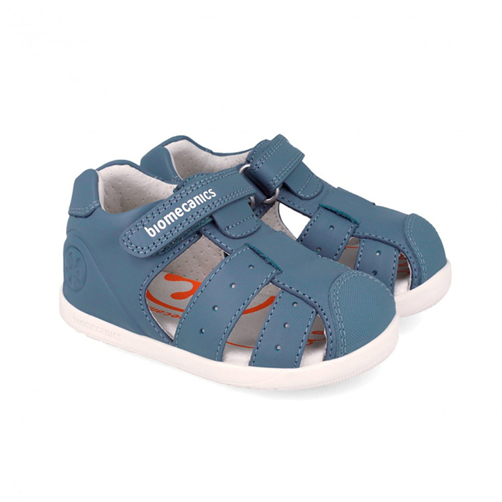 Blue children's sandal with white sole on a white background