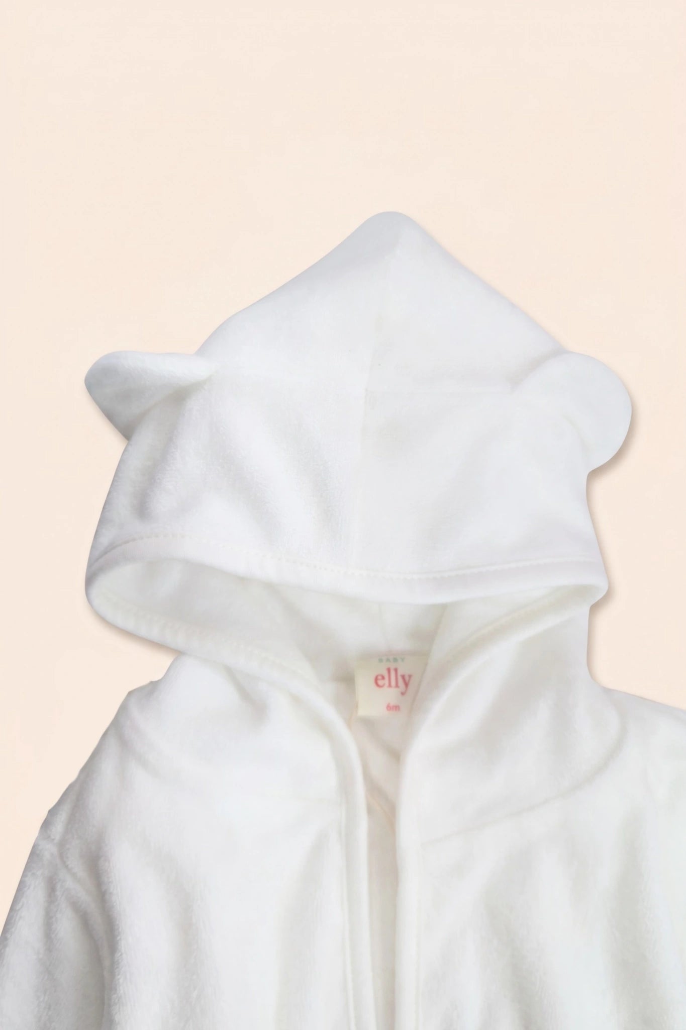 Close-up of white bear bathrobe hood with small rounded ears detail