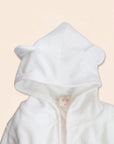 Close-up of white bear bathrobe hood with small rounded ears detail