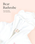 Close-up of personalised white Bear bathrobe embroidery detail on soft neutral background