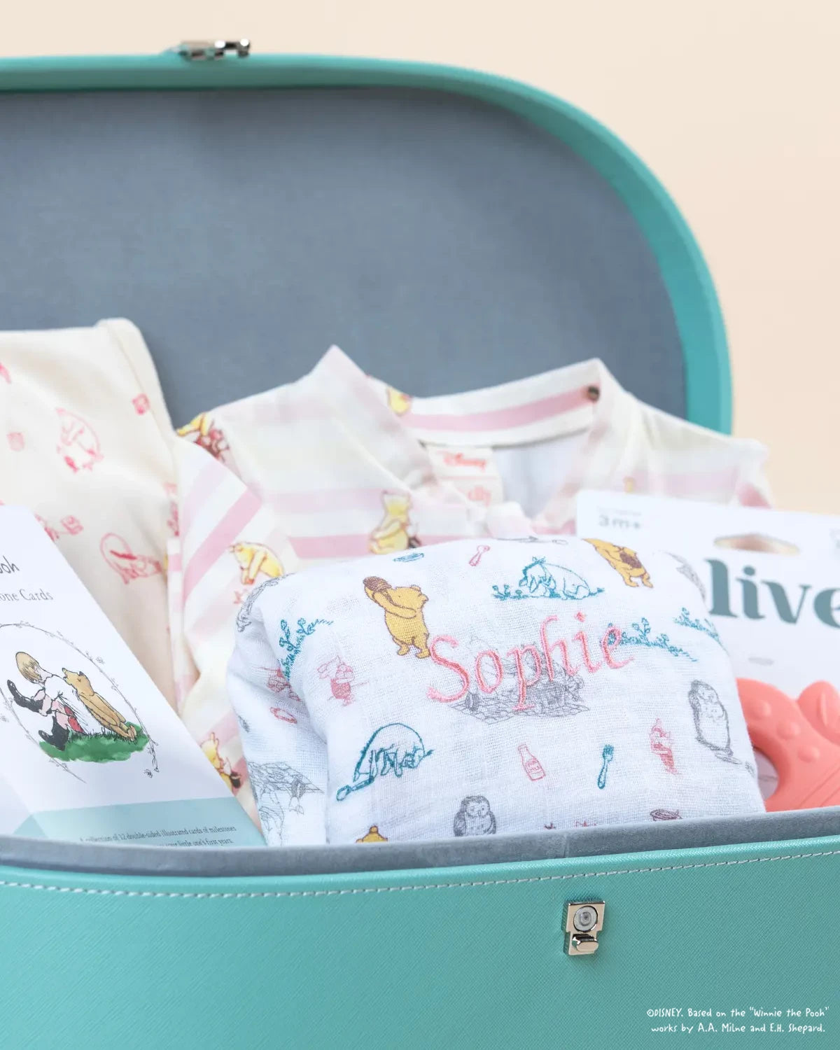 Collection of baby products with illustrations in a teal gift box