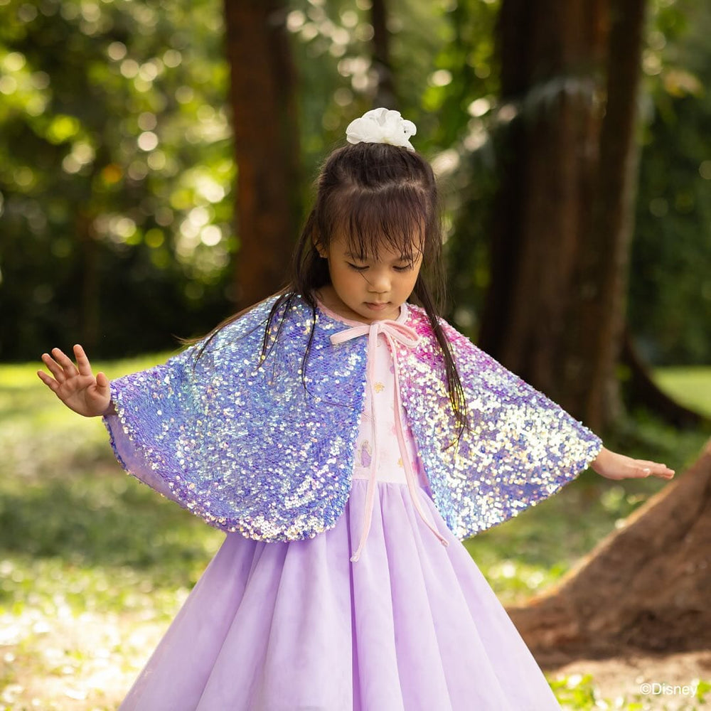 Girl in purple dress and cape