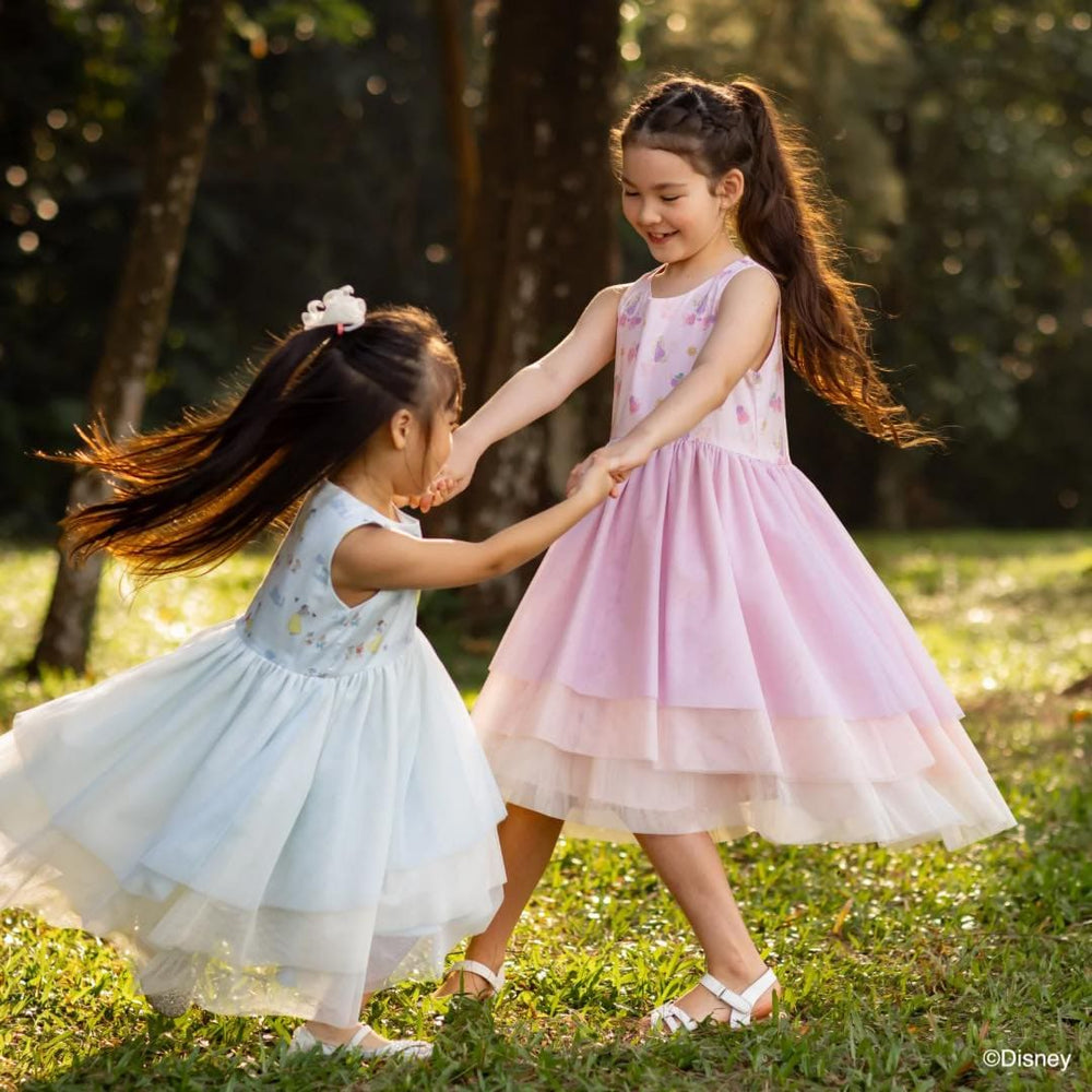Two girls dancing in dresses