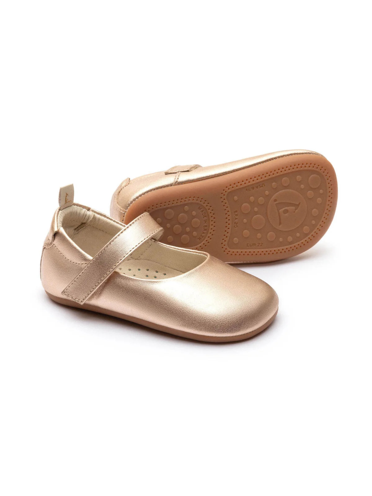 Pair of metallic salmon pink leather Mary Jane baby shoes featuring a soft-sole design and adjustable strap.