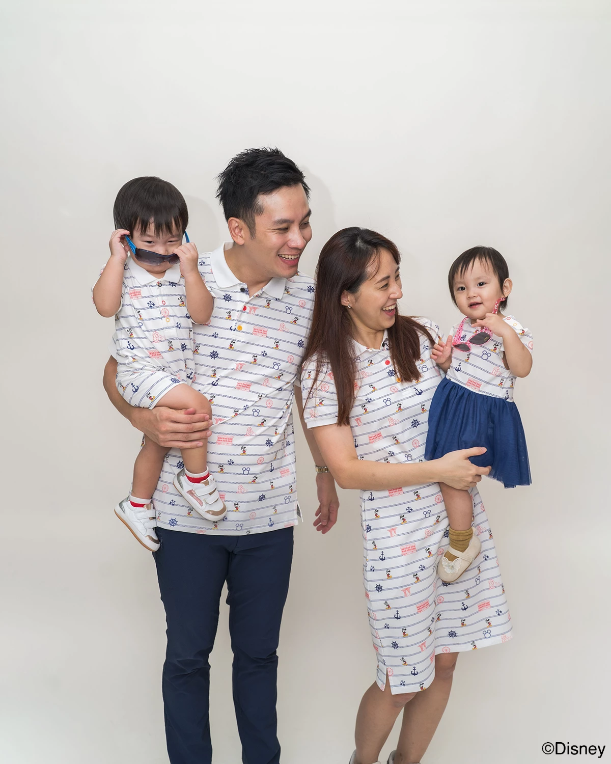 Family of four wearing matching nautical mickey outfits 