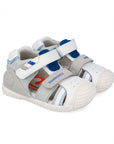 Children's sandal with gray and white and blue accent design on a white background