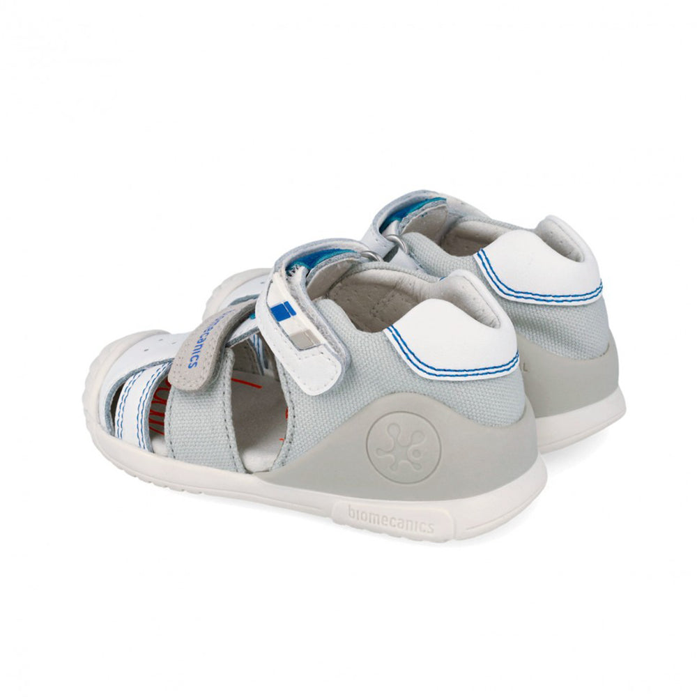 Children's sandal with gray and white and blue accent design on a white background