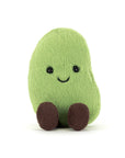 Green bean plush toy with a smiling face on a white background
