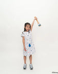 Child wearing hayley dress in nautical mickey holding a toy against a plain background