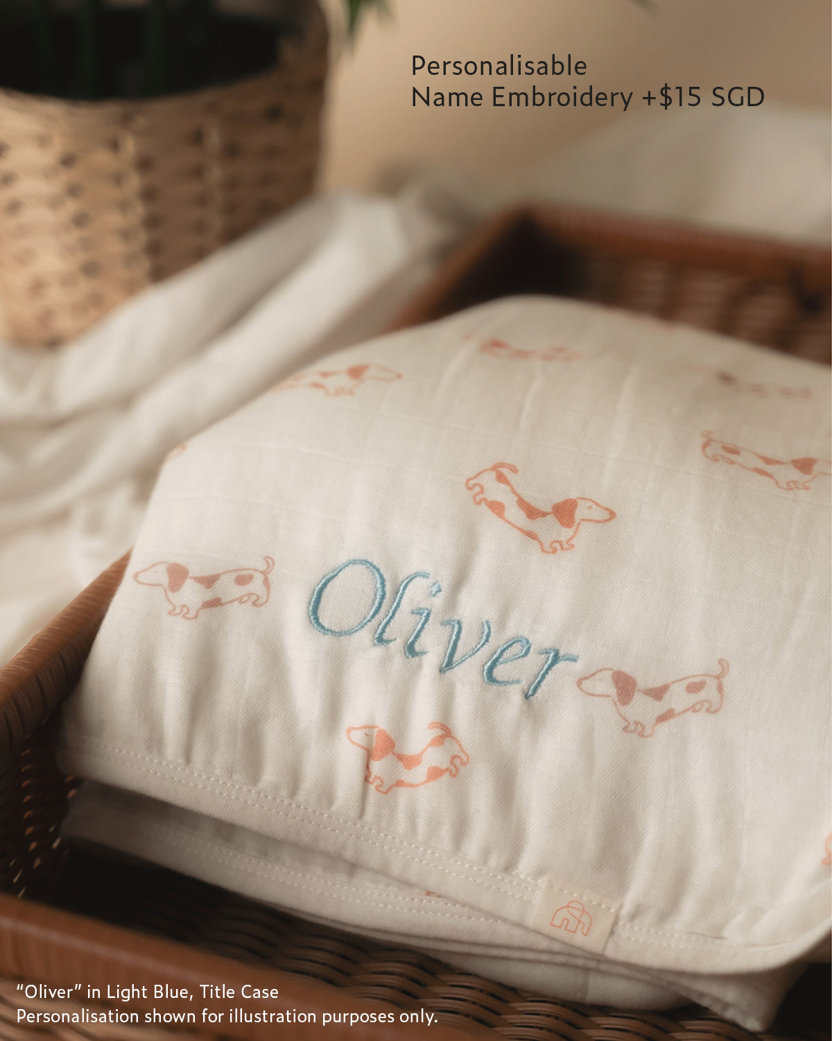 Personalisable name embroidery on bamboo muslin swaddle blanket with "oliver" in light blue thread title case 