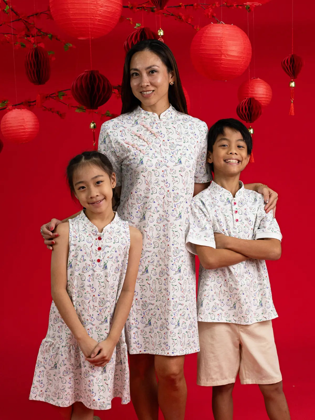 Elly family matching outfits: Naomi Cheongsam, Ladies Dress, and Boys shirt in Zodiac Mahjong.