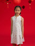 Girls' Naomi Cheongsam by Elly in Zodiac Mahjong print against a red background.