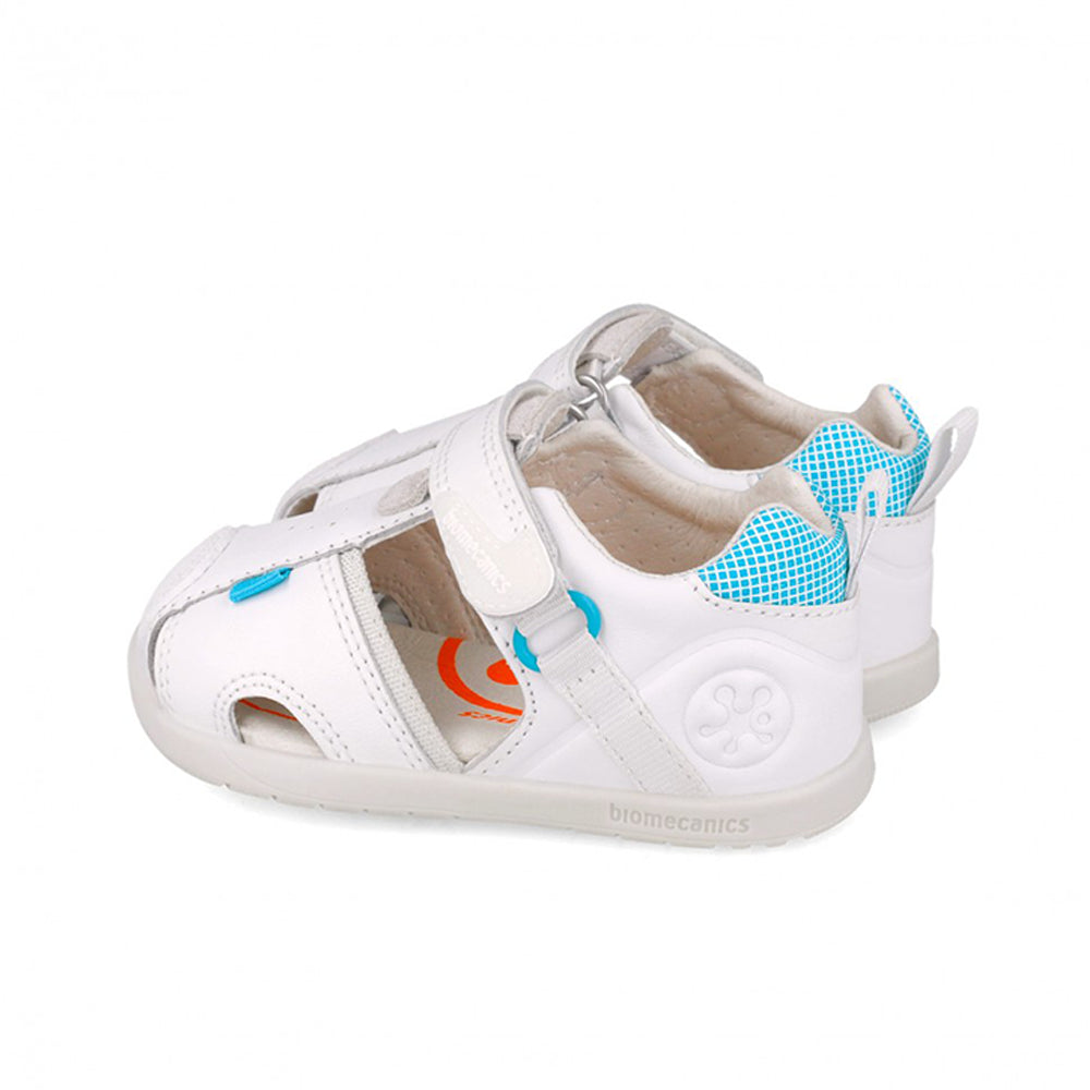 White sandal with blue accents on a white background