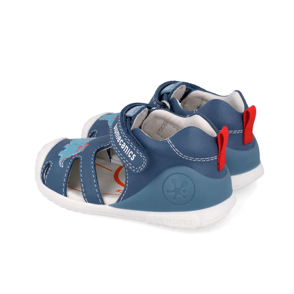 Pair of blue children's sandals with red straps on a white background