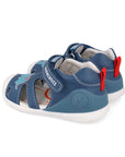Pair of blue children's sandals with red straps on a white background