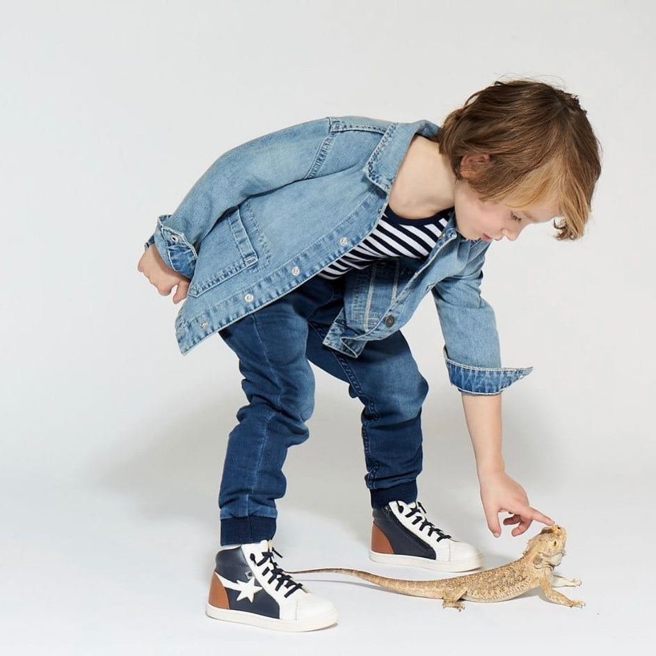 Boy in denim jacket with lizard