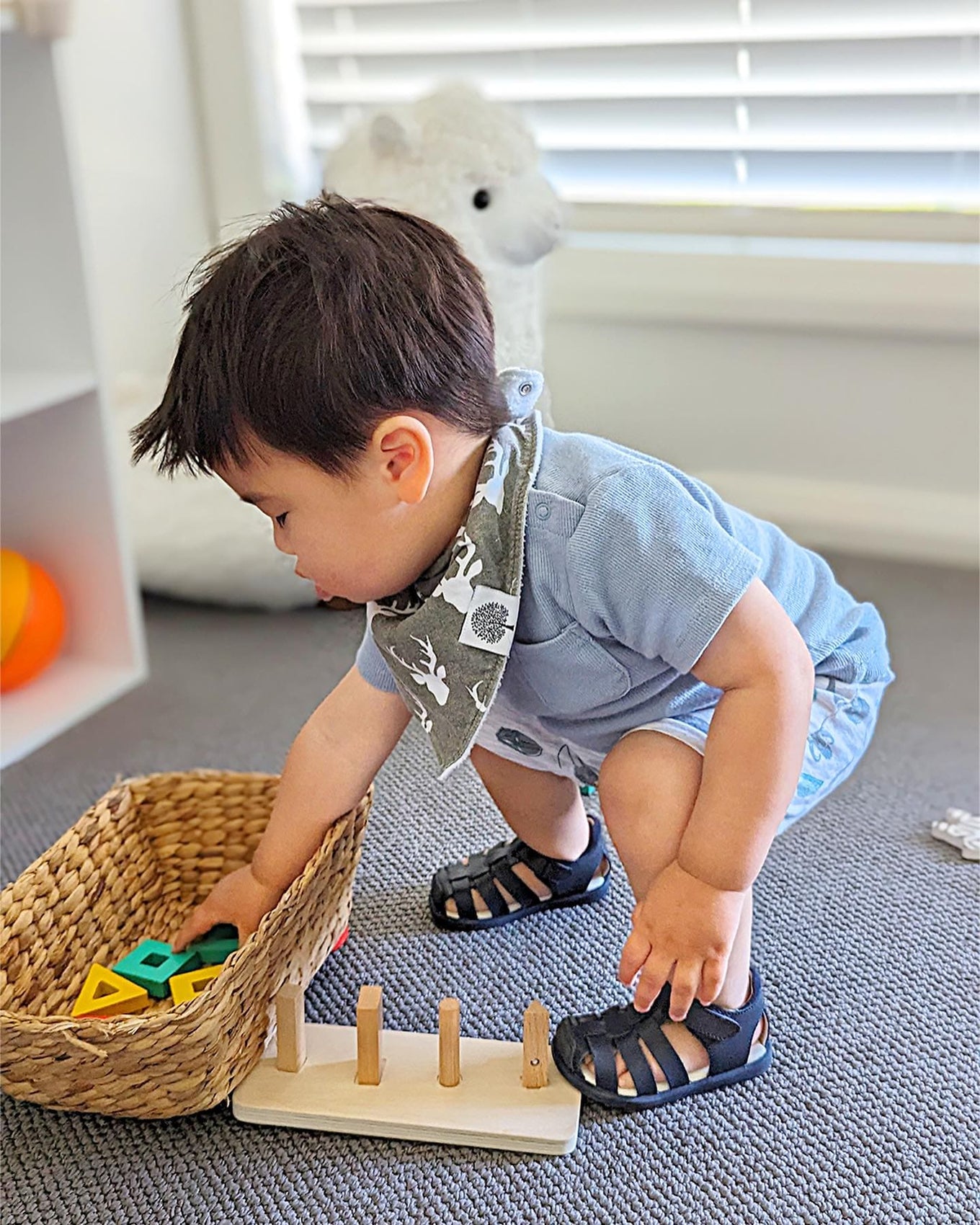 Toddler in sandals playing with wooden toys - old soles gallery 4