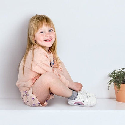 Old Soles gallery - child smiling wearing shoes