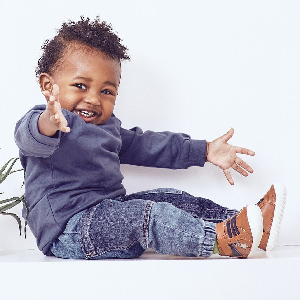Happy toddler wearing brown shoes