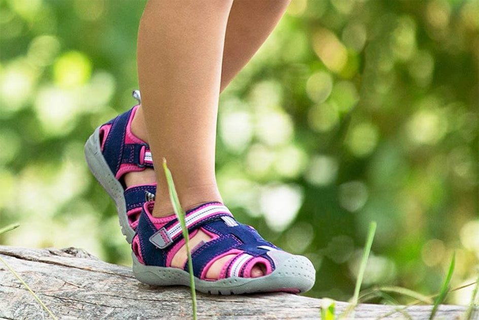 Pediped sandals for kids on a log