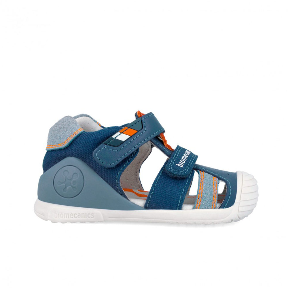Blue children's sandal with white sole on a white background