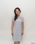 Woman wearing stripes sailor mickey polo dress with a logo on a white background