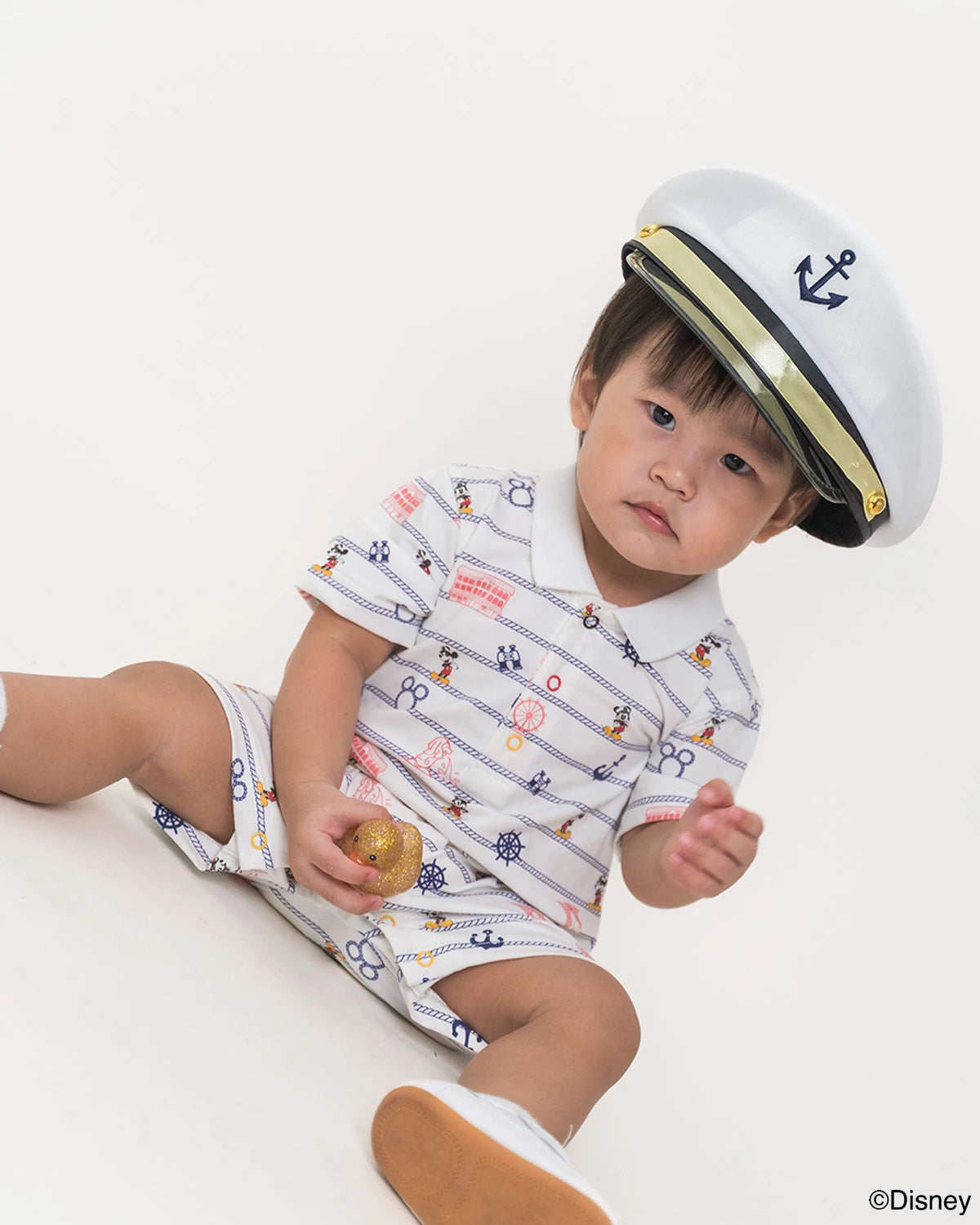 Baby wearing short sleeve romper in nautical mickey  
