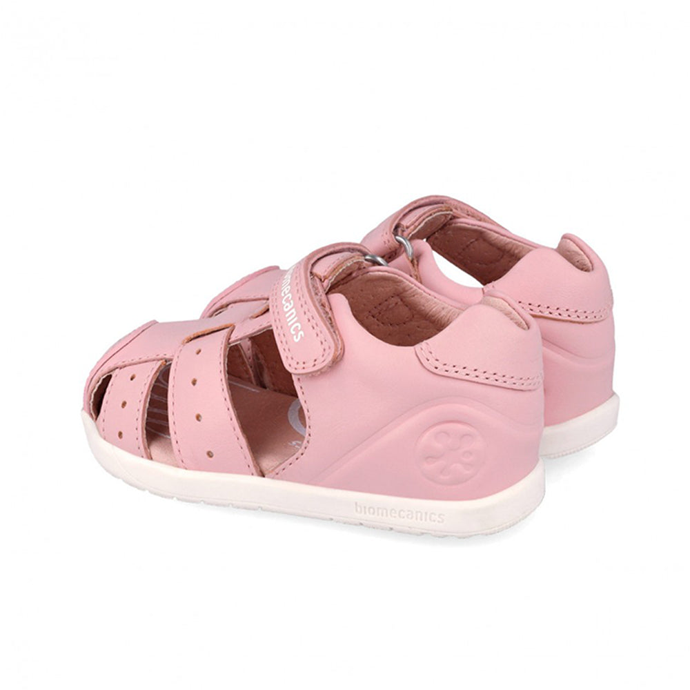 Pair of pink children's sandals on a white background