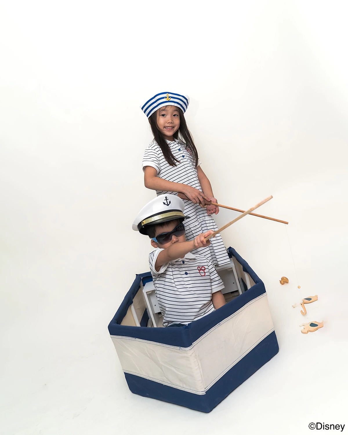Two children in matching sailor mickey stripes outfits 