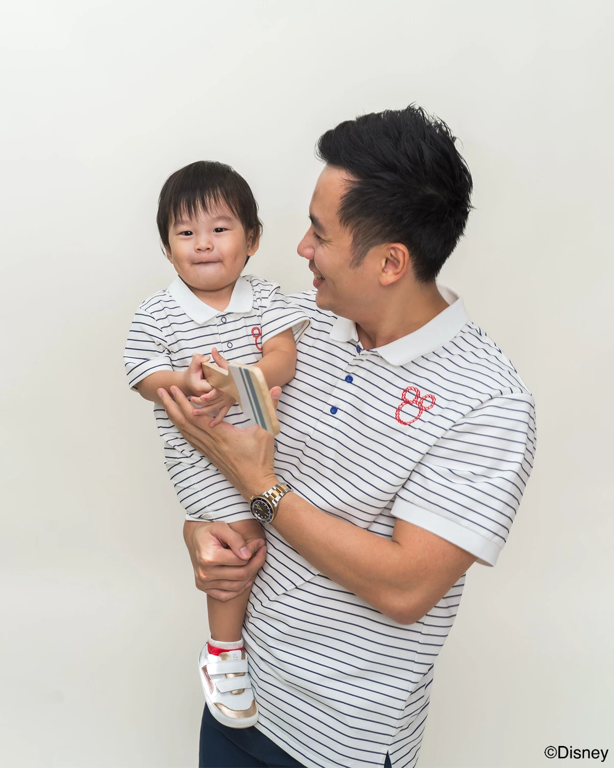 Father and child wearing matching stripes sailor mickey 