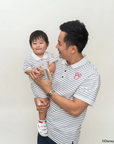 Father and child wearing matching stripes sailor mickey 