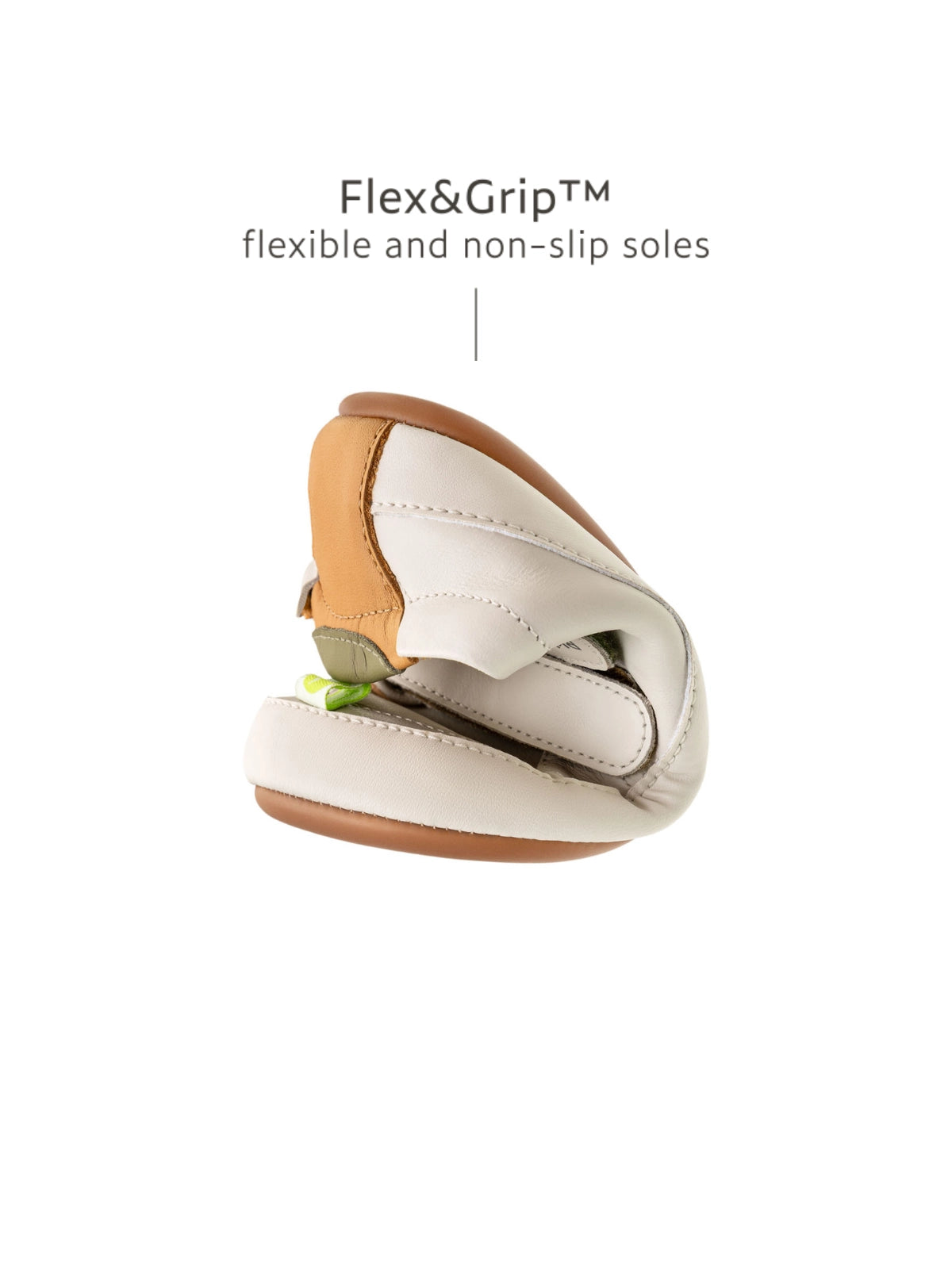 A Tapioca and green baby sneaker folded to show the Flex&Grip non-slip, ultra-flexible rubber sole.