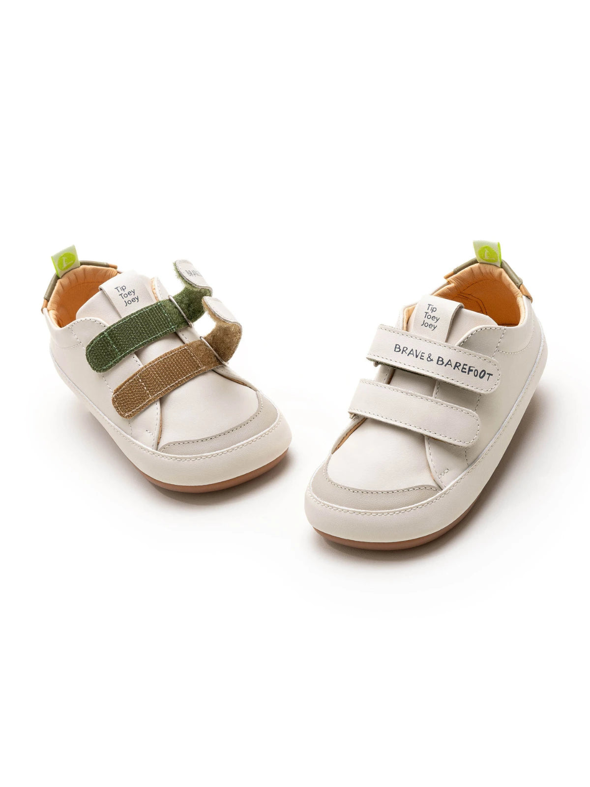 A pair of Tapioca white and green leather baby sneakers with a wide toe box and easy-strap closure.