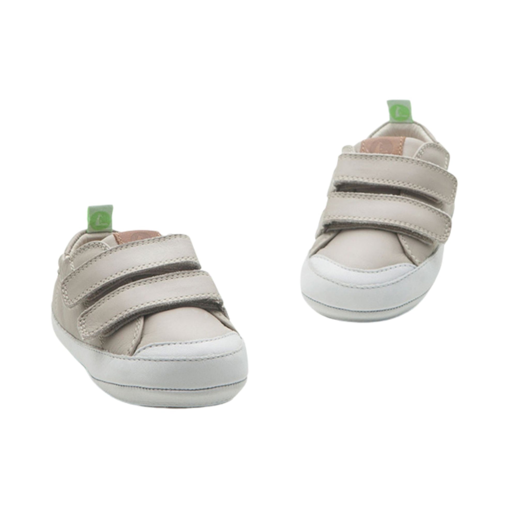 A pair of Pumice grey leather baby sneakers showing the wide toe box and easy-on double strap design.