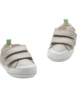 A pair of Pumice grey leather baby sneakers showing the wide toe box and easy-on double strap design.