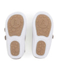 Bottom view of Bossy baby sneakers showing the split rubber traction pods on the white flexible sole.