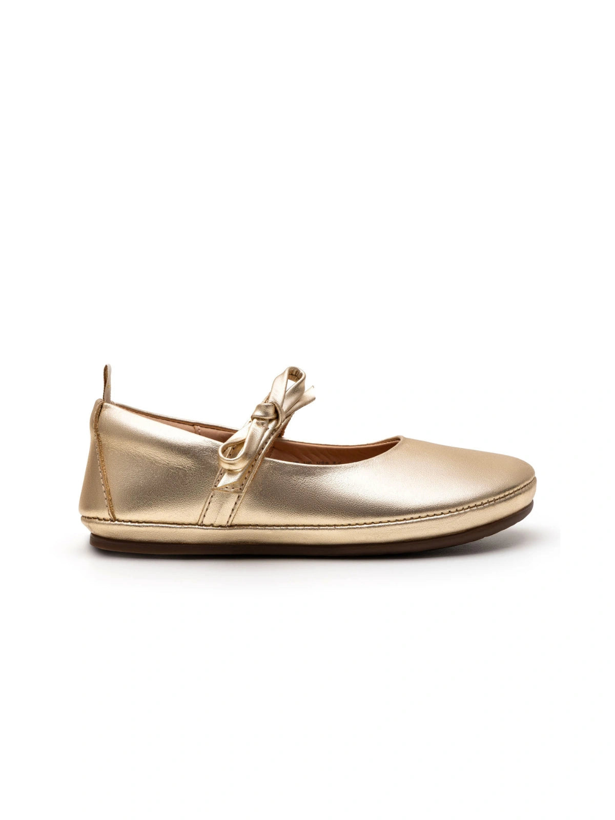Side view of the metal gold Brigitte kids shoe showing the low profile and flat, ergonomic sole design.