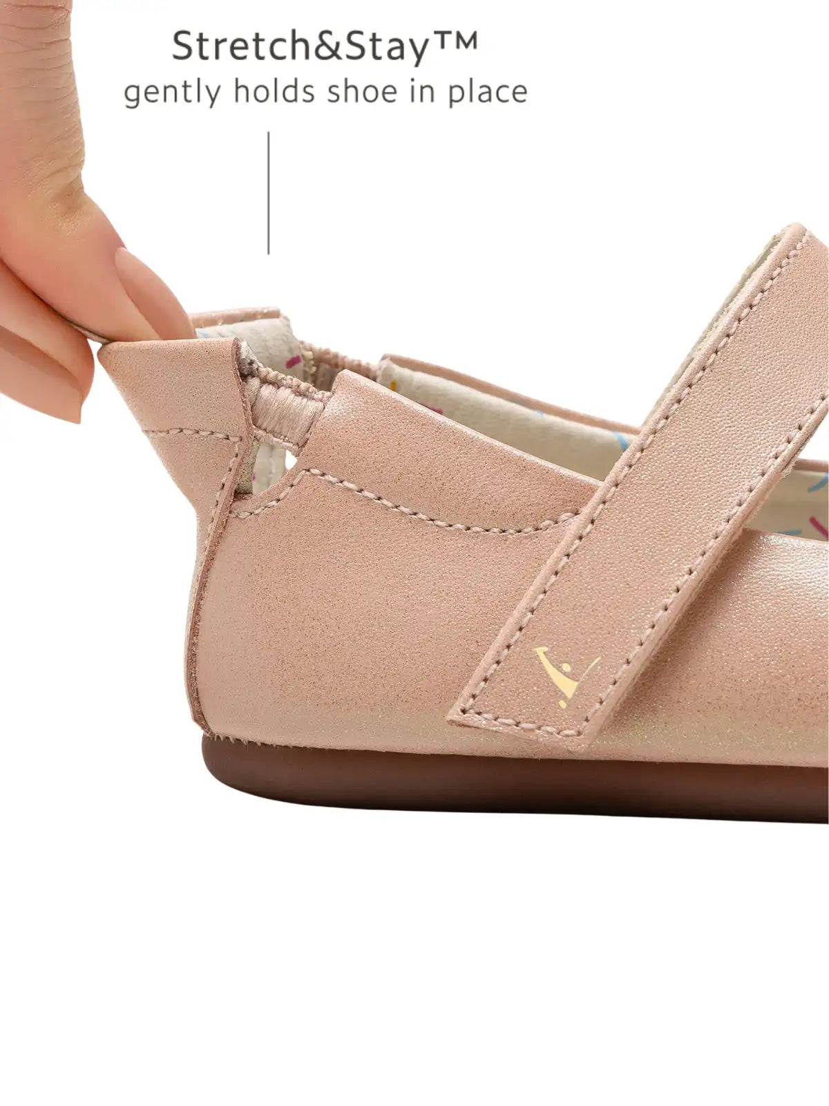 Close-up of the Stretch&amp;Stay elasticated heel being pulled to show secure fit on a pink leather shoe.
