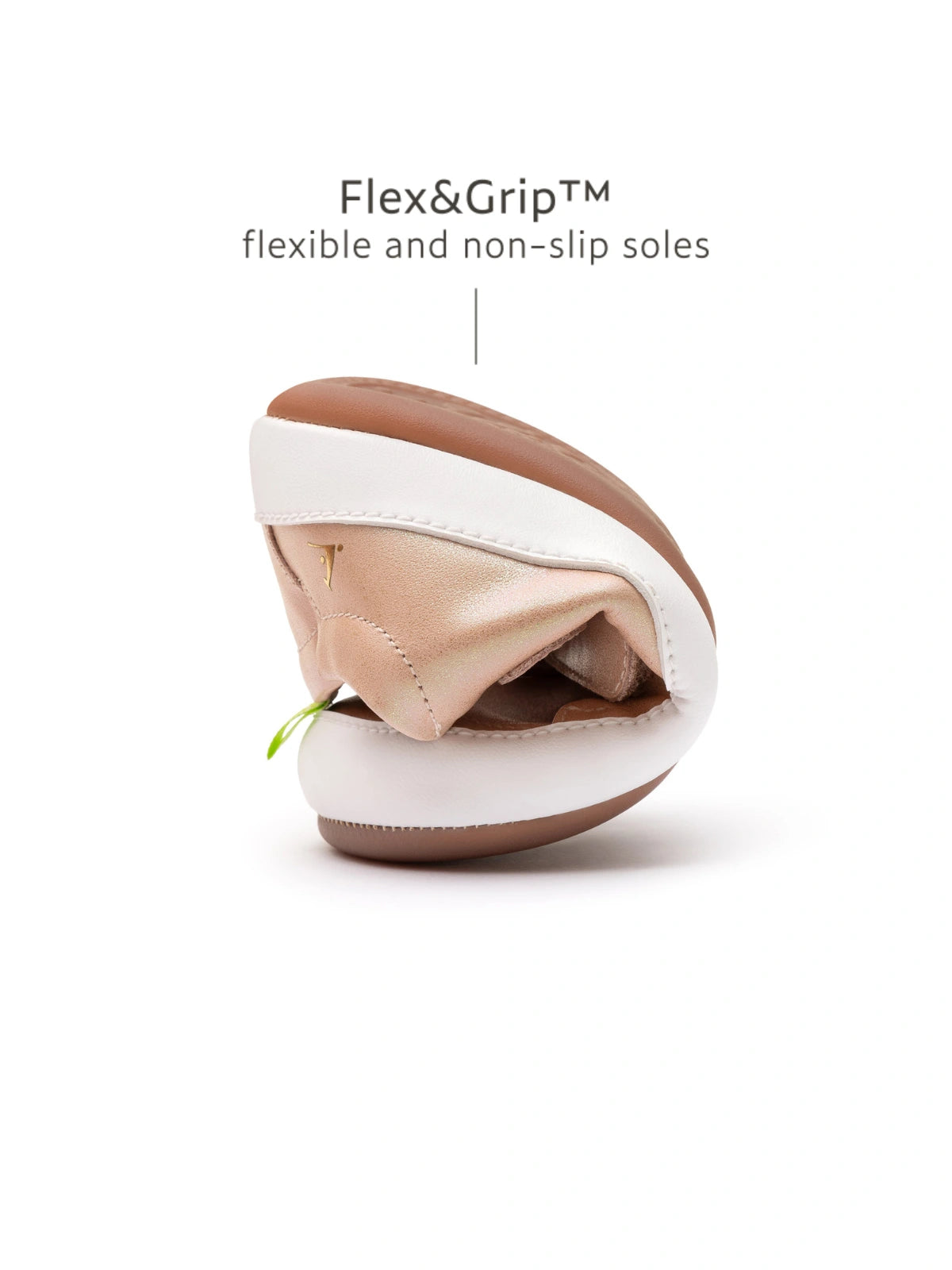 Demonstrating the flexible FlexiGrip rubber sole on the baby candy dream pink leather sneaker.