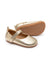 A pair of soft-sole champagne gold leather Mary Jane baby shoes with a flexible rubber sole and adjustable strap.