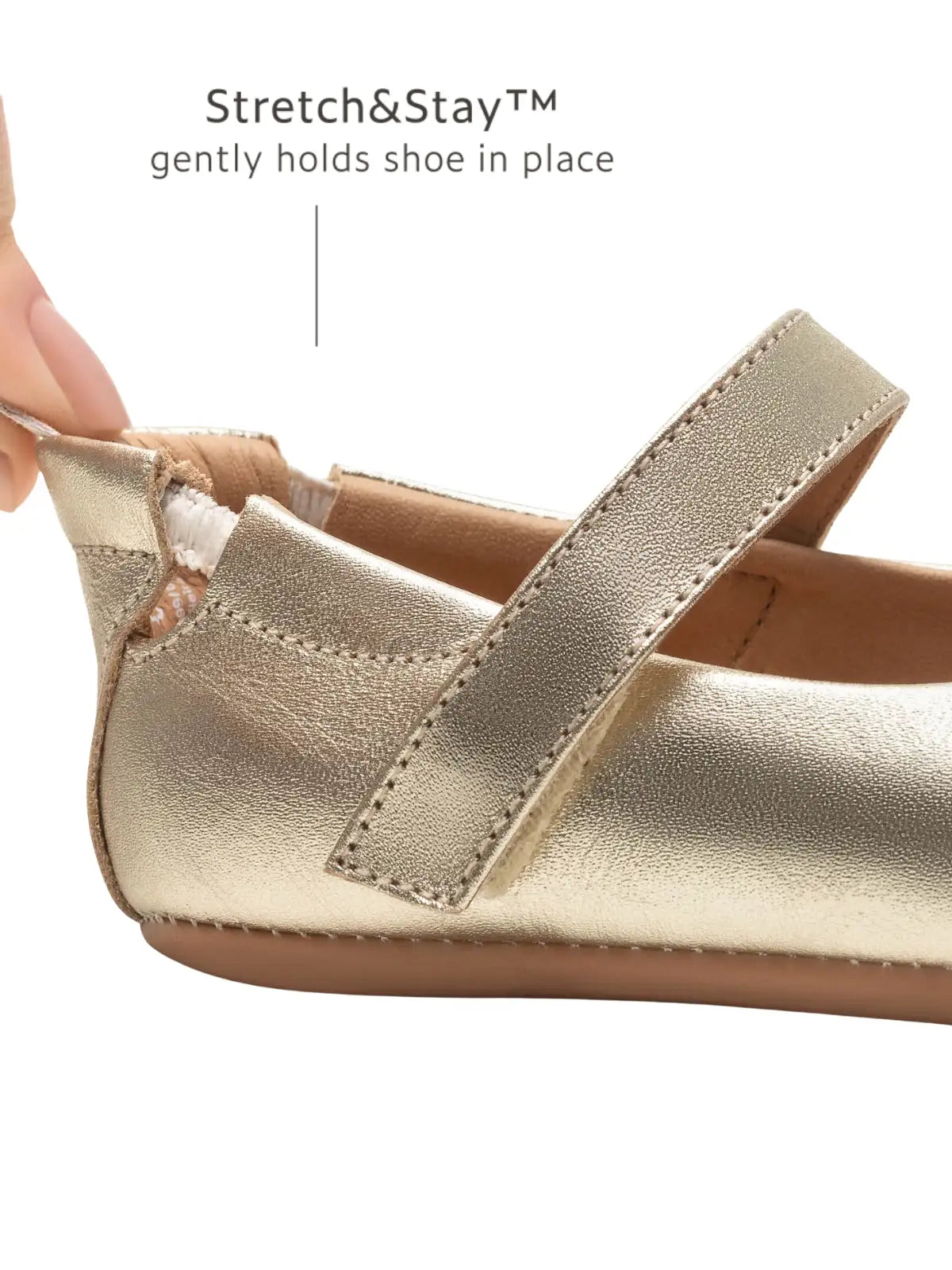 Close-up of the champagne gold leather baby shoe showing the Stretch and Stay elastic heel for a secure fit and easy dressing.