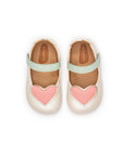 Overhead view of antique white baby shoes featuring pink heart patches and a wide toe box for natural foot growth.