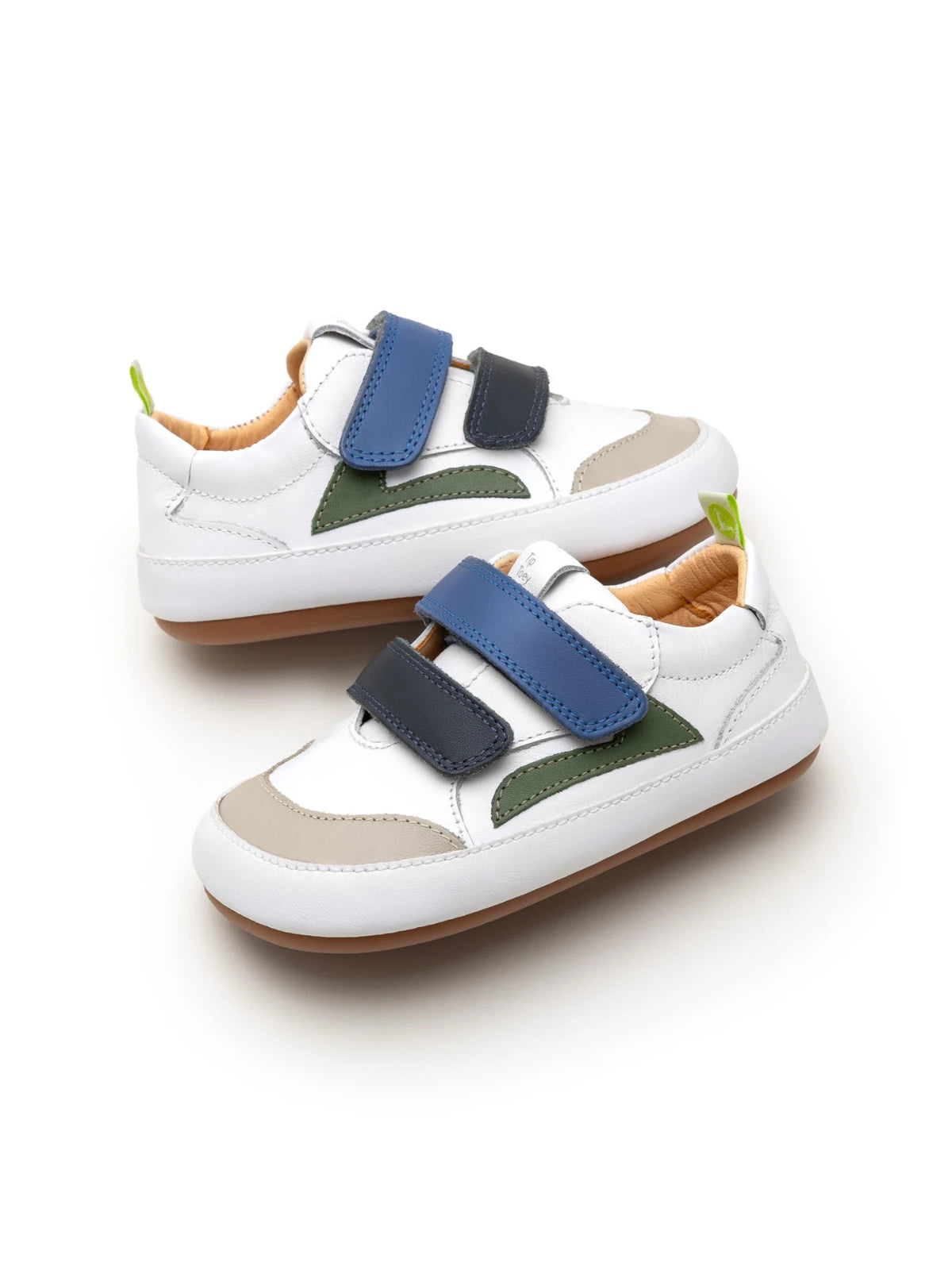Angled view of the baby Landy sneakers in white and navy, showing the wide toe box and sporty leather panels.