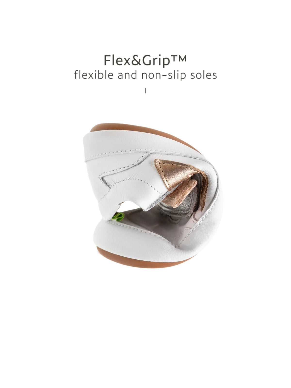 Showing the flexible FlexiGrip rubber sole on the white and rose gold baby sneaker to support natural movement.