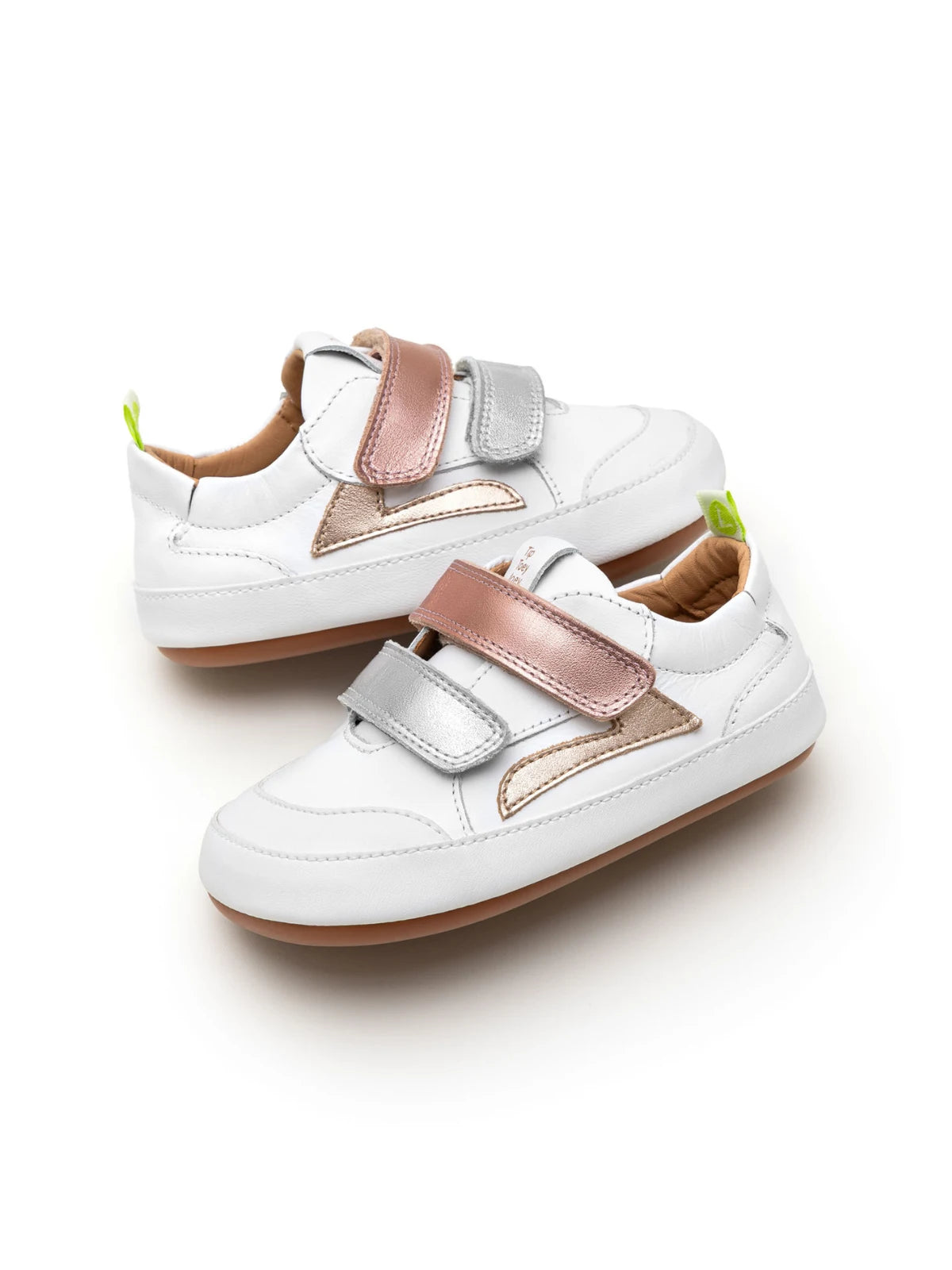 Angled view of baby Landy sneakers in white with rose gold and silver panels, featuring a wide toe box design.